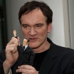 Quentin Tarantino poses with his action figure
