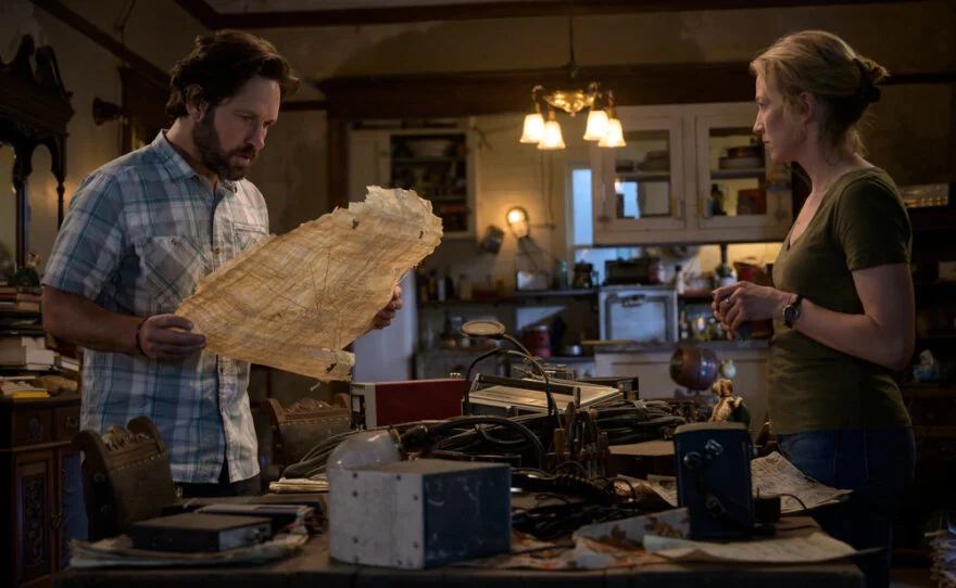 Mr. Gary Grooberson (Paul Rudd) and Callie (Carrie Coon) examine a weathered map in Ghostbusters: Afterlife